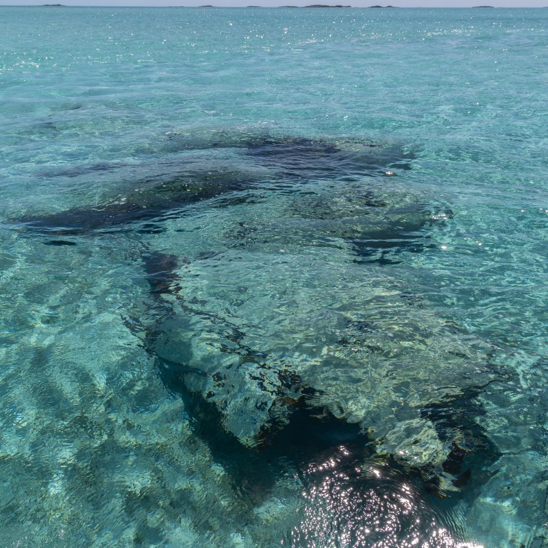 Clear turquoise water with visible rocks underneath the surface.